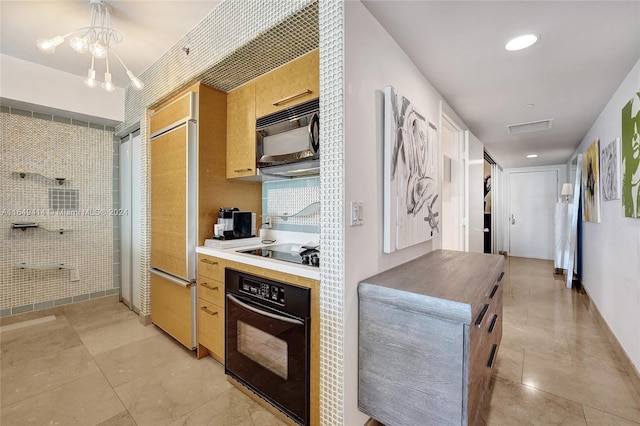 kitchen with black appliances, tasteful backsplash, an inviting chandelier, and hanging light fixtures