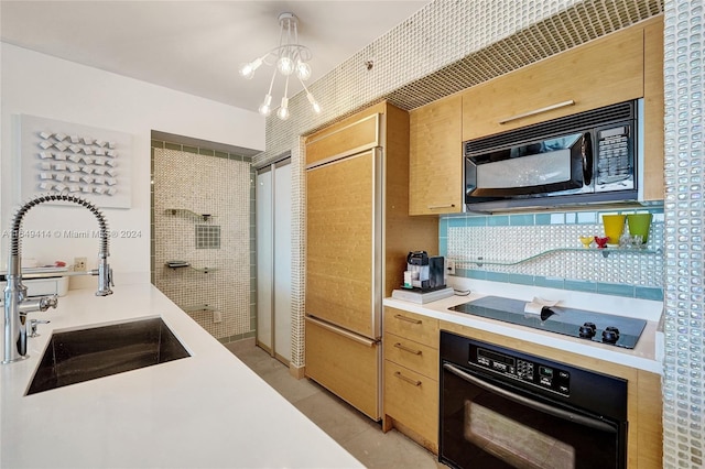 kitchen with light tile patterned floors, a notable chandelier, sink, black appliances, and decorative backsplash