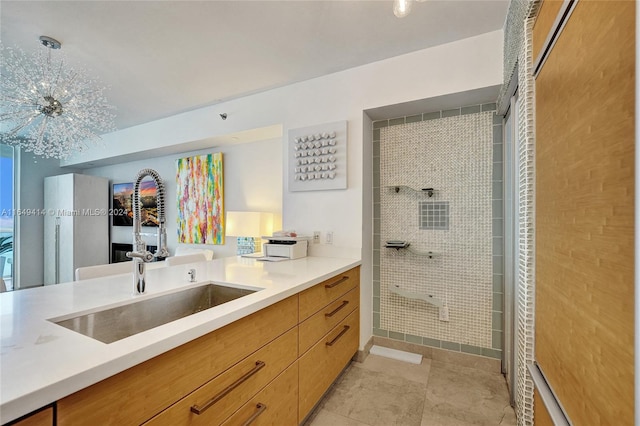 kitchen with sink, light tile patterned floors, and decorative light fixtures