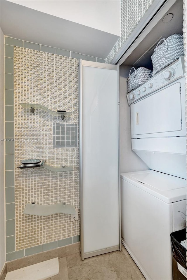 clothes washing area with stacked washer / drying machine