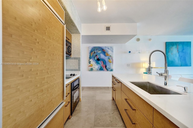 kitchen featuring black appliances and sink