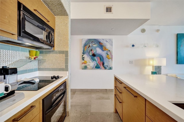 kitchen featuring black appliances, light tile patterned floors, and tasteful backsplash