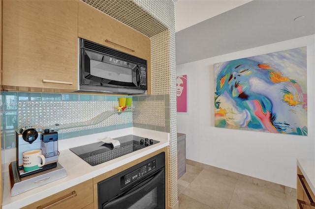 kitchen featuring black appliances, light brown cabinetry, light tile patterned floors, and backsplash