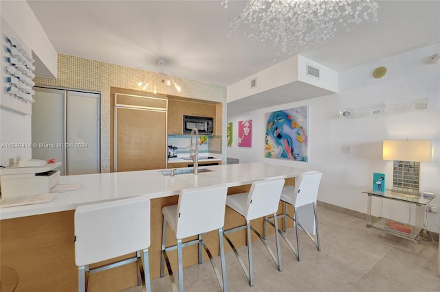 kitchen featuring a kitchen bar and decorative light fixtures