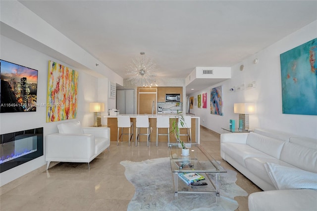 living room with a chandelier and sink