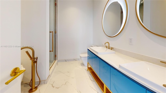 bathroom with vanity, toilet, and a shower with door