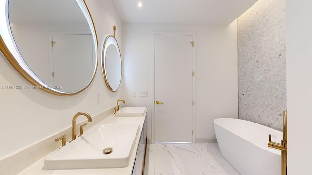 bathroom featuring vanity and a washtub