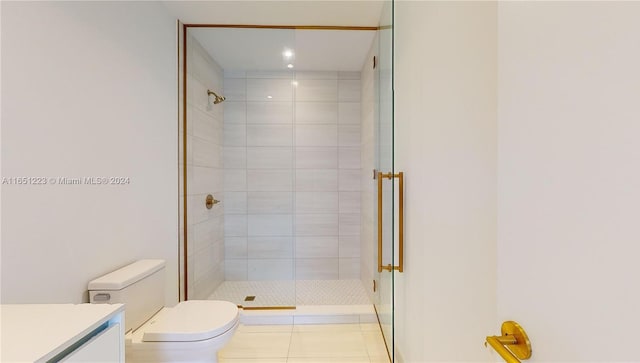 bathroom with vanity, toilet, an enclosed shower, and tile patterned flooring