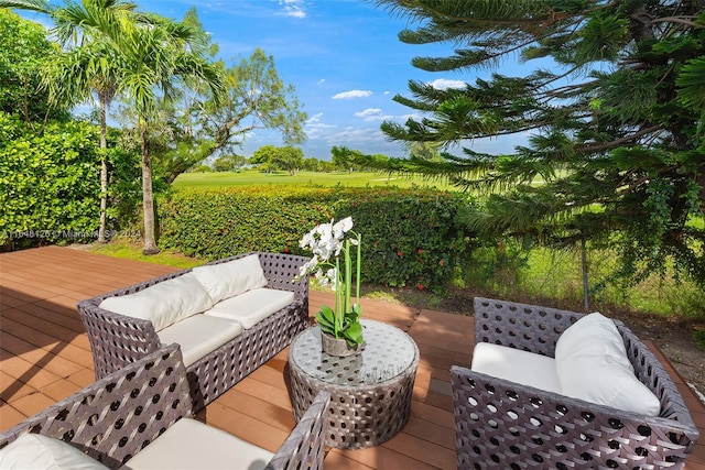 wooden deck with an outdoor living space