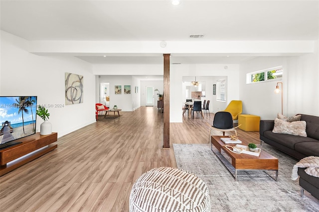 living room featuring an inviting chandelier and hardwood / wood-style floors