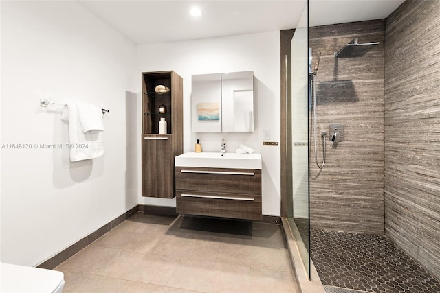 bathroom featuring tiled shower, vanity, toilet, and tile patterned floors