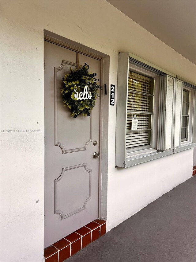 700 Layne Blvd Unit 212, Hallandale Beach, FL 33009 - doorway to property with stucco siding