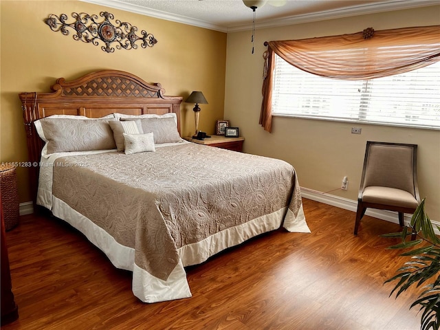 bedroom with hardwood / wood-style floors and ornamental molding