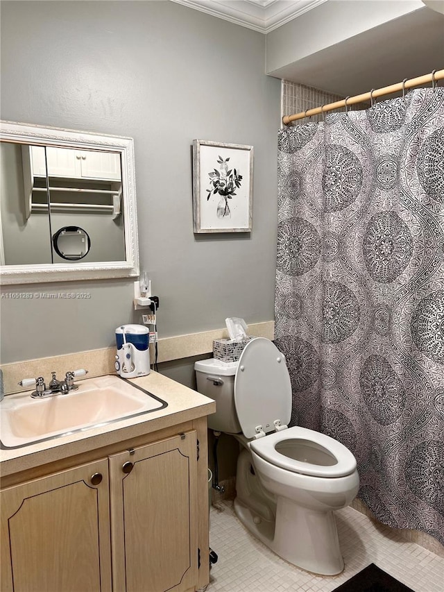 bathroom featuring tile patterned flooring, vanity, toilet, and crown molding