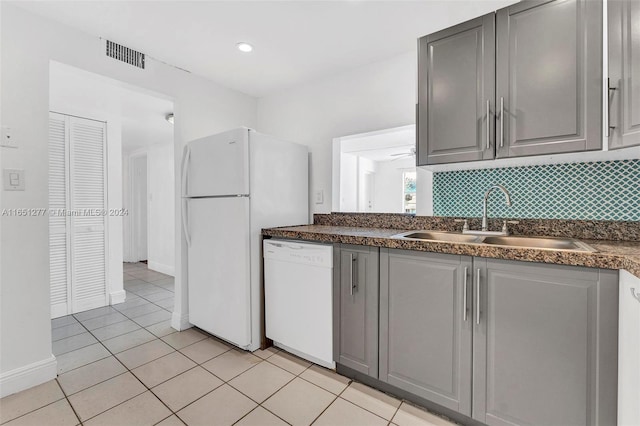 kitchen featuring white appliances, backsplash, sink, gray cabinets, and light tile patterned flooring