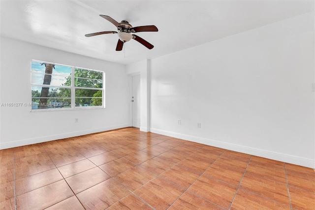 tiled empty room featuring ceiling fan