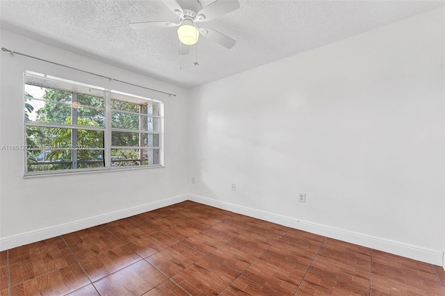 spare room featuring a textured ceiling, ceiling fan, and hardwood / wood-style floors