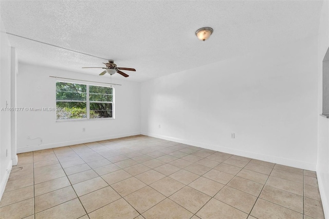 tiled spare room featuring ceiling fan and a textured ceiling