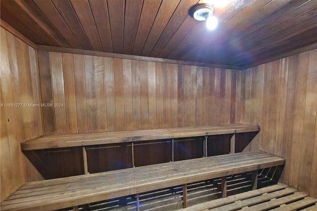 view of sauna / steam room with wooden walls and wooden ceiling