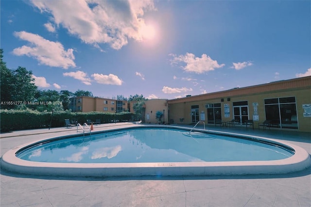 view of swimming pool with a patio area