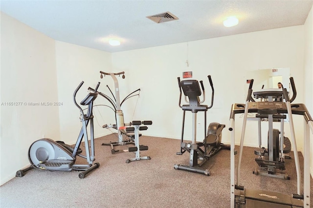 workout room with a textured ceiling