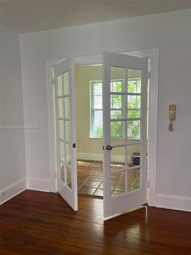 doorway with dark hardwood / wood-style floors and french doors