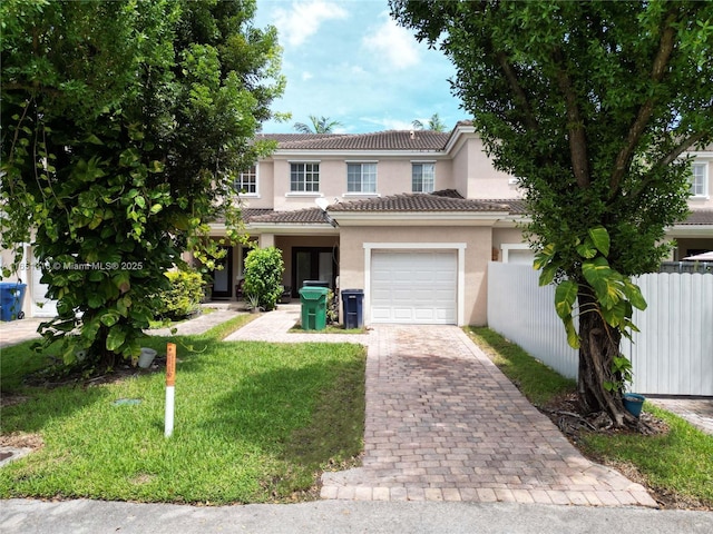 view of front of house featuring a front yard and a garage