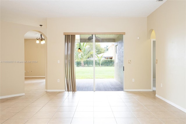 tiled spare room with a healthy amount of sunlight