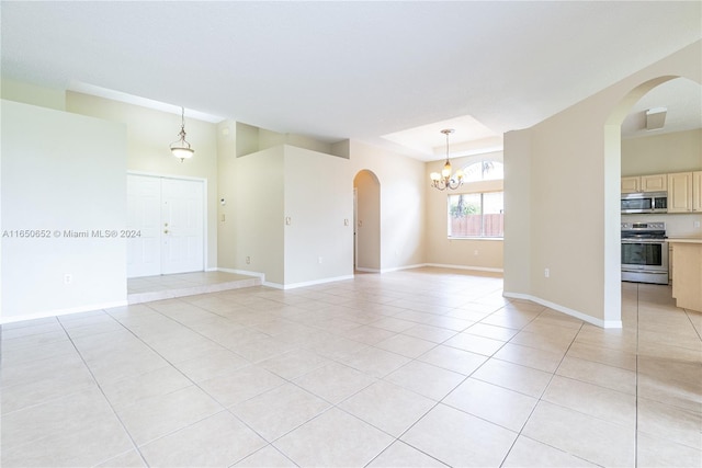 spare room featuring light tile patterned floors and a chandelier