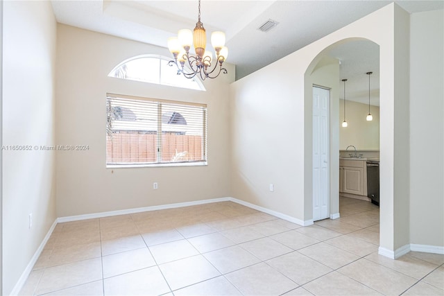 tiled empty room featuring sink and a notable chandelier