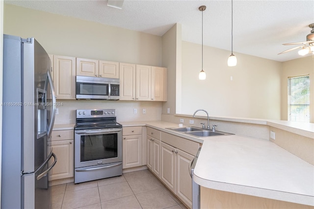 kitchen featuring decorative light fixtures, appliances with stainless steel finishes, ceiling fan, and sink