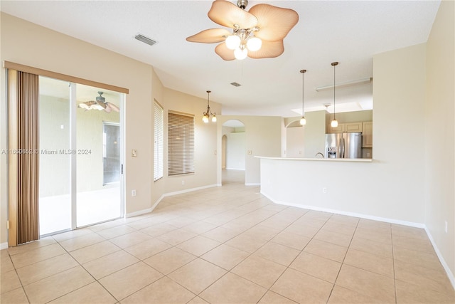 spare room with ceiling fan and light tile patterned flooring