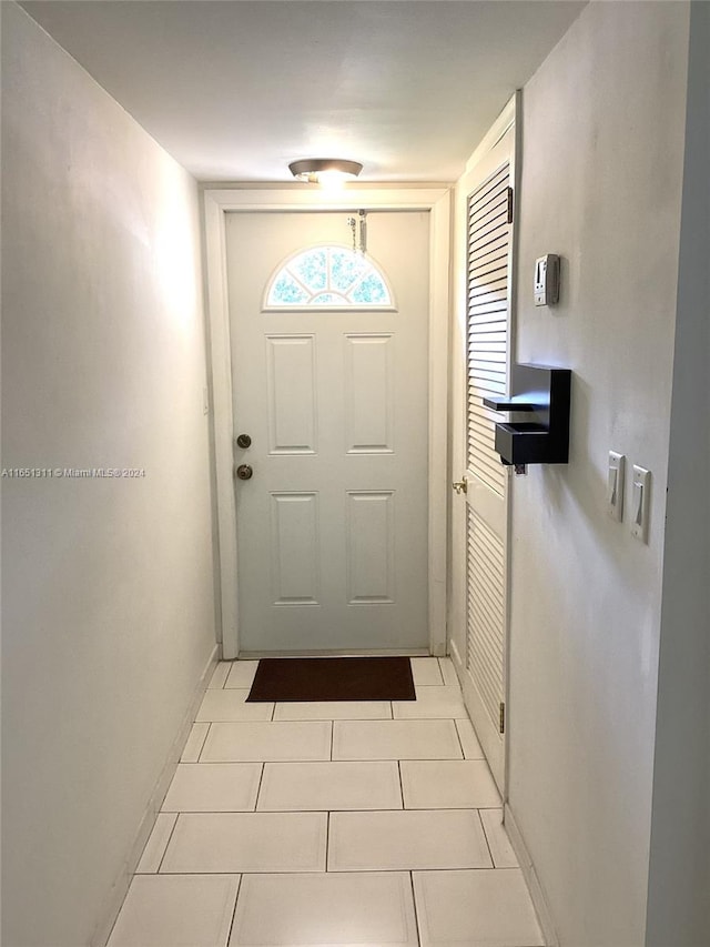 doorway to outside featuring light tile patterned floors