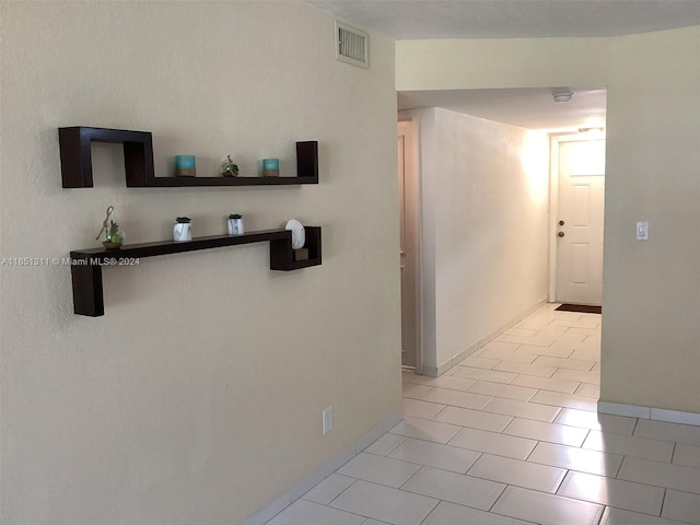 hallway featuring light tile patterned floors