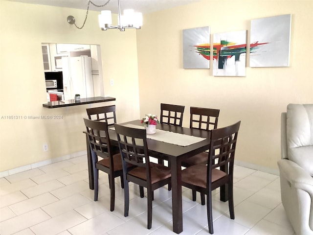 dining room with a notable chandelier and light tile patterned floors