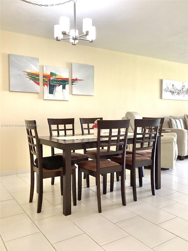 tiled dining area with a notable chandelier