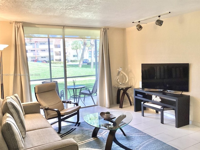 611 S Hollybrook Dr Unit 102, Pembroke Pines, FL 33025 - tiled living area with expansive windows, rail lighting, and a textured ceiling