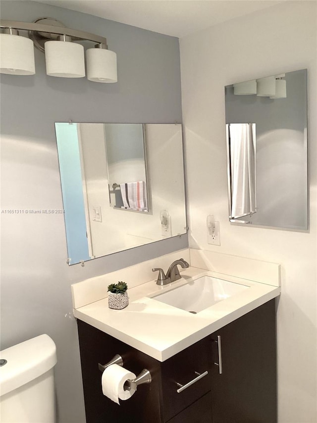 bathroom featuring vanity and toilet