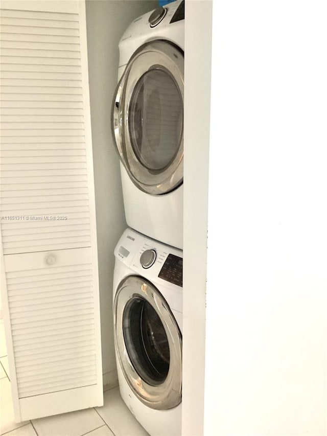 611 S Hollybrook Dr Unit 102, Pembroke Pines, FL 33025 - laundry room with stacked washing machine and dryer and light tile patterned flooring