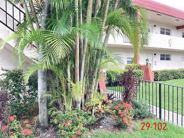 view of property exterior featuring a lawn and a balcony