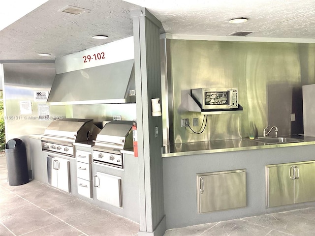 611 S Hollybrook Dr Unit 102, Pembroke Pines, FL 33025 - kitchen featuring stainless steel counters, a sink, and a textured ceiling
