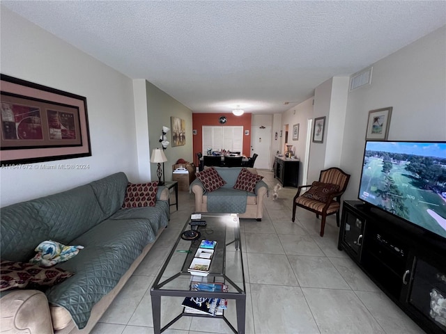 living room with light tile patterned floors and a textured ceiling