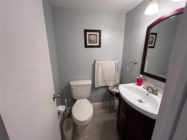 bathroom with tile patterned floors, toilet, and vanity