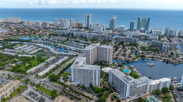 birds eye view of property featuring a city view and a water view