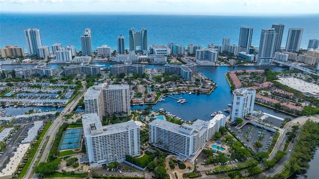 birds eye view of property with a city view and a water view