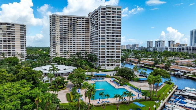 pool featuring a city view, a patio, and a water view