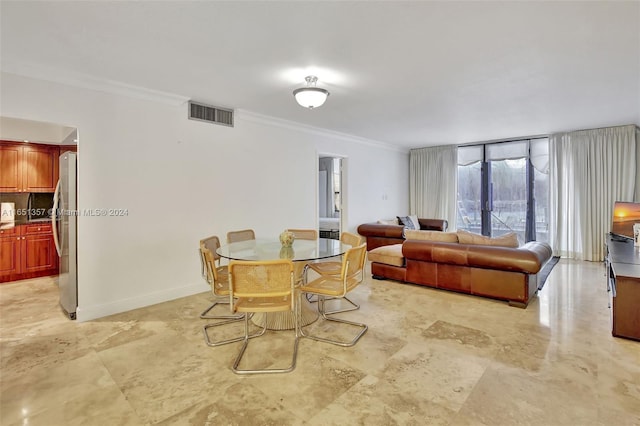 dining area with ornamental molding