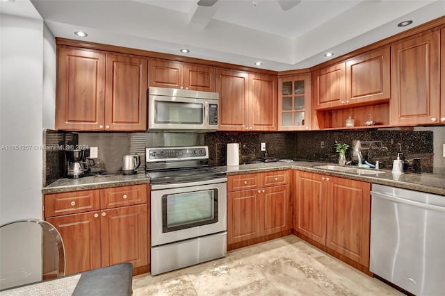 9801 Collins Ave Unit 3T, Bal Harbour, FL 33154 - kitchen with brown cabinetry, decorative backsplash, recessed lighting, a sink, and stainless steel appliances