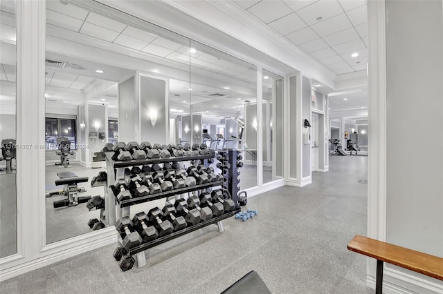 exercise room with crown molding and a drop ceiling