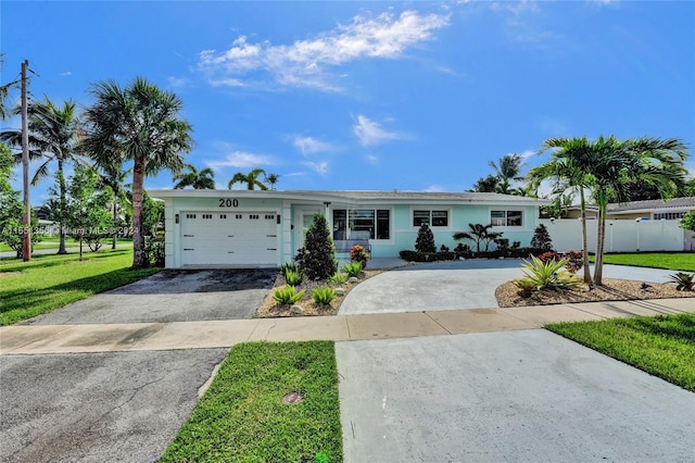 ranch-style house featuring a garage and a front yard